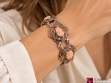 woman wearing a white shirt and a bracelet with pink stones