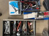 a box of tools sitting on the floor next to a pair of shoes