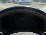 steering wheel of a car on the road with a truck in the background