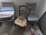 two chairs and a bed in the corner of a room