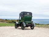 an old green car parked on the side of the road
