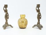 two gold vases sitting next to each other on a white surface