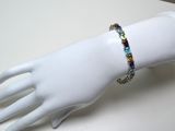 a white mannequin hand with a bracelet on it