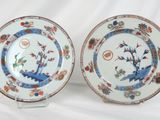 pair of chinese plates with birds and flowers on them on a white background