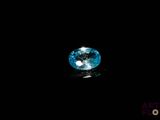 a close up of a blue diamond on a black surface