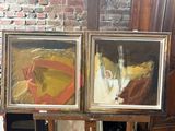 three paintings on easels in a room with a brick wall