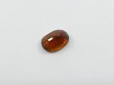 a close up of a brown gemstone on a white surface