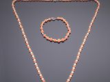 an orange and white beaded necklace and bracelet set