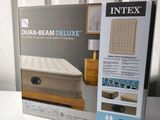 the box of the mattress is open on the bed in the box