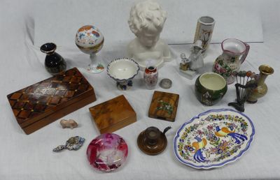 a table with a bust and a lot of items on it