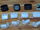 many different types of airpods sitting on a wooden table