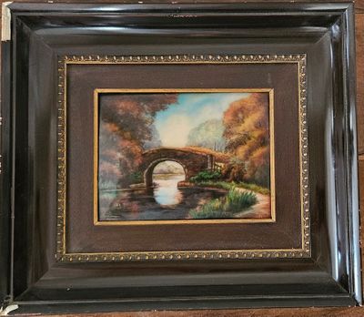 painting of a bridge over a river in a wooden frame
