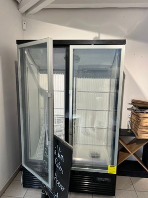 an image of a refrigerator in a room with a sign on the floor