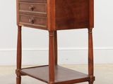 an image of a small wooden table with drawers on it