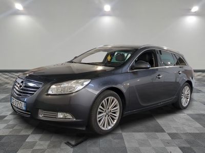 a picture of a grey car parked in a garage