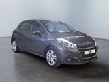 the grey car is parked in a large room with a black floor