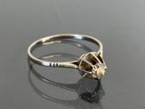 a close up of a diamond ring on a black surface