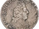 gros plan d'une pièce de monnaie sur laquelle figure une tête de femme