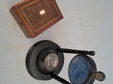 a small wooden box with a mirror and a magnifying glass