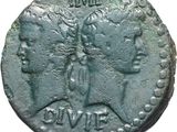 a close up of a coin with a woman and a man on it