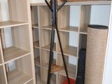 a coat rack in the corner of a room with shelves