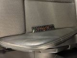 a close up of a seat in a car with a remote control