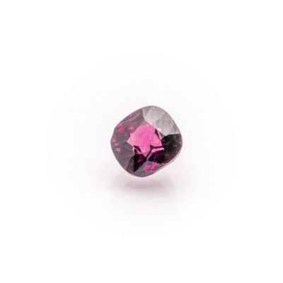 a close up of a pink diamond on a white surface