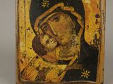 an old wooden icon of a woman holding a child