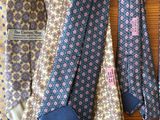 several ties are lined up on a wooden table