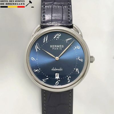 a close up of a wrist watch with a blue dial