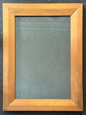 an empty picture frame on a wall with a black background