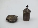 a small metal object with a cross on it