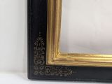 an old picture frame with a gold and black border