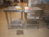 two stainless steel tables in the middle of a kitchen