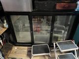 two stools that are sitting in front of a refrigerator