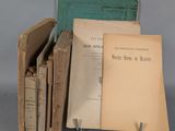 several old books are stacked on top of each other on a table