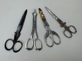 five pairs of scissors sitting next to each other on a table