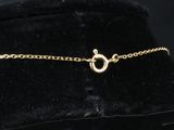 a close up of a black hat with a gold chain on it