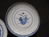 two plates with blue and white designs on them on a table