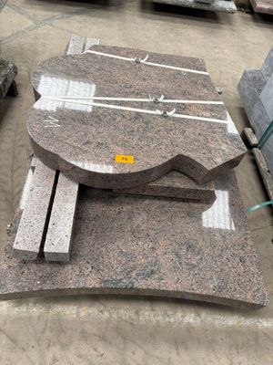 many pieces of granite on the ground in a warehouse