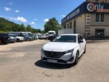 une voiture blanche garée devant un bâtiment