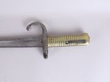 a very old looking sword on a white surface