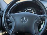 a steering wheel and dashboard of a car in a parking lot