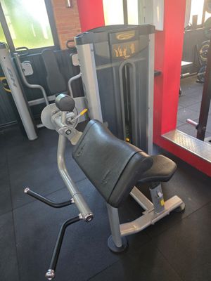 a gym room with a tread machine and a mirror