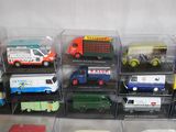 many different types of toy trucks in a display case