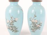two vases with flowers painted on them on a white background