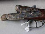 an old gun is on a table with a tag on it
