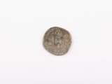 a close up of a silver coin on a white surface