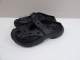 black children ' s sandals with two straps on them sitting on a white surface