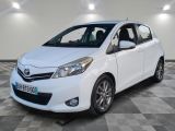 the white toyota yaris is parked on a checkered floor